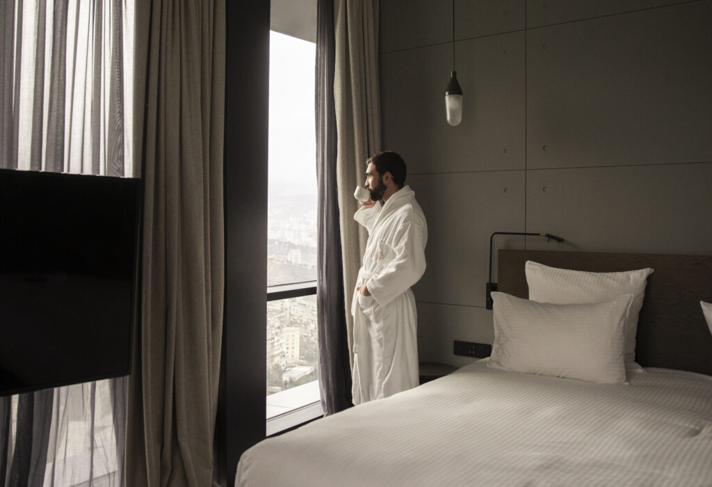 Guest looking at the Tbilisi skyline from a room at Pullman Tbilisi Axis Towers