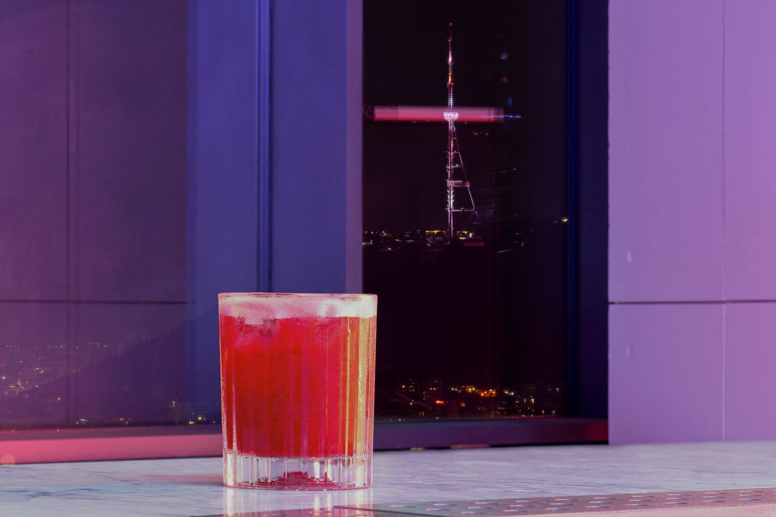 Cocktail at Weather Report Sky Bar with the city below