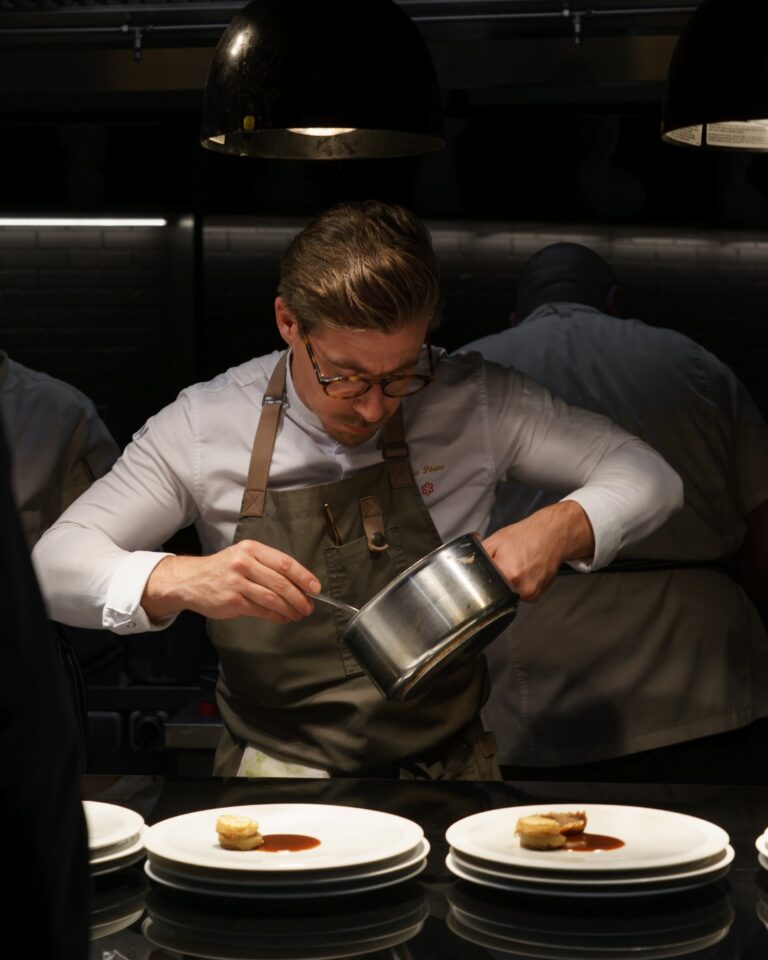 Chef finishing plates at Dumas