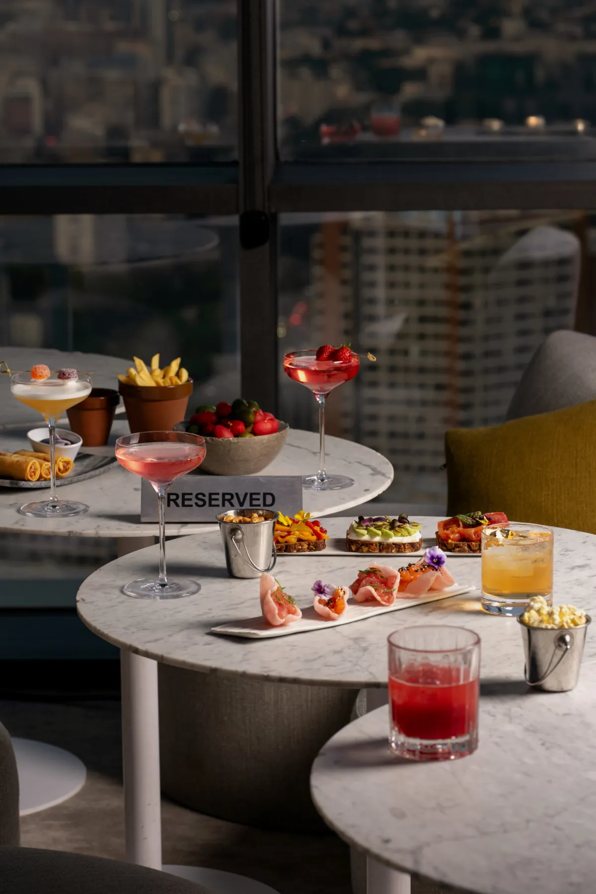 Cocktails and small plates on a reserved table at Weather Report Sky Bar
