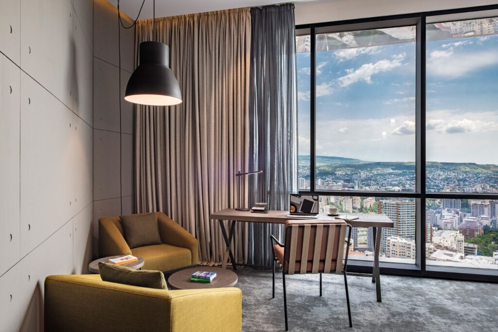 Executive Room seating area with city view, Pullman Tbilisi