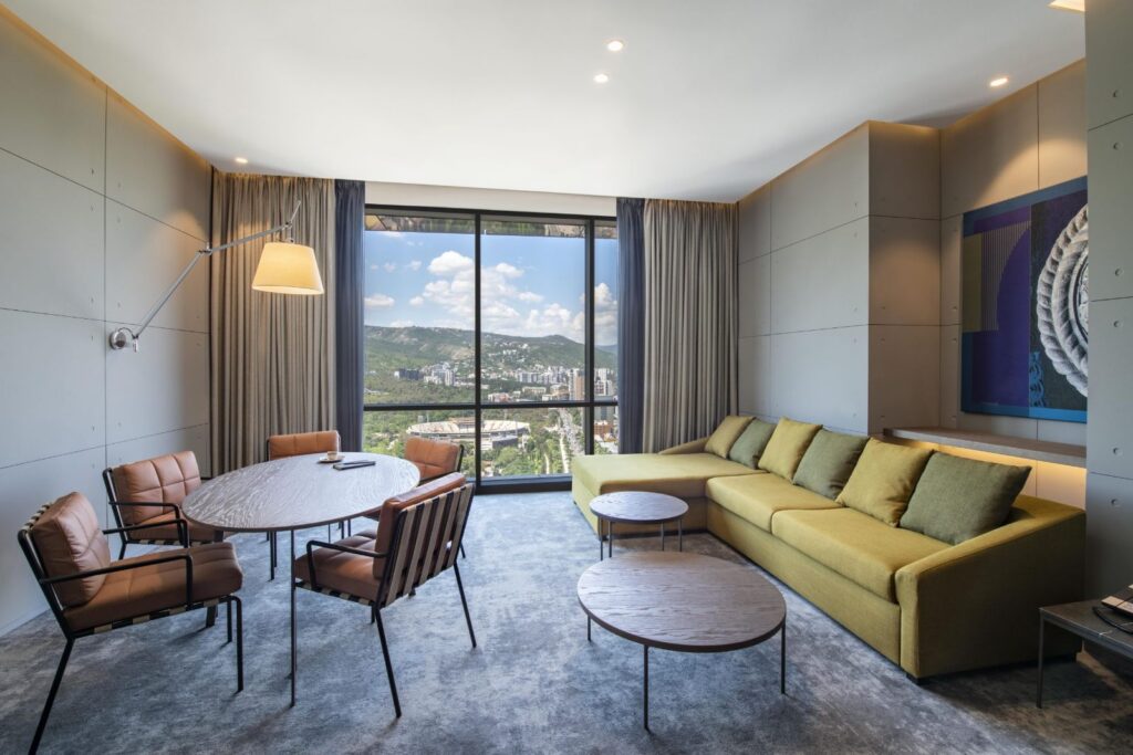 Superior Suite living room with dining table, Pullman Tbilisi