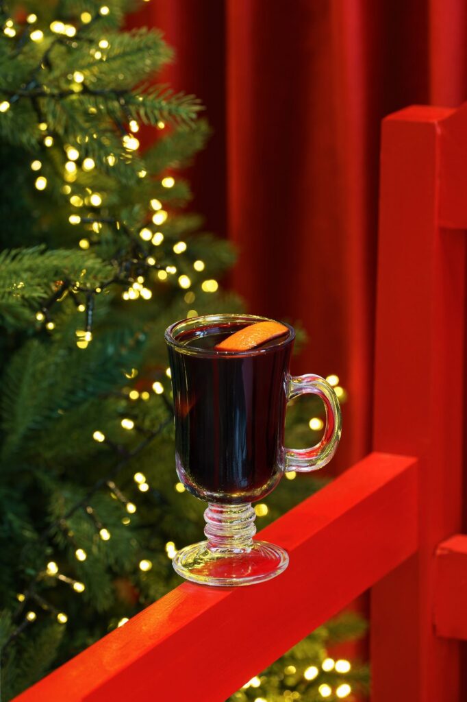 Mulled wine by a lit Christmas tree